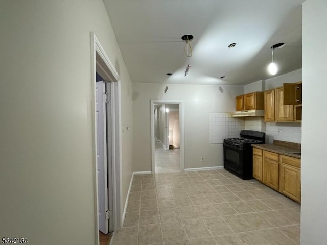 kitchen featuring under cabinet range hood, decorative backsplash, gas stove, and baseboards