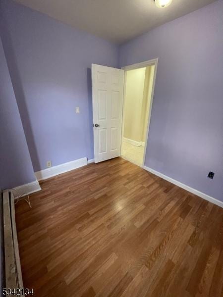 unfurnished bedroom featuring baseboards and wood finished floors