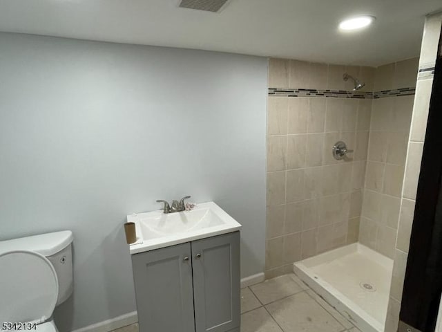 full bathroom featuring tile patterned flooring, visible vents, toilet, and tiled shower