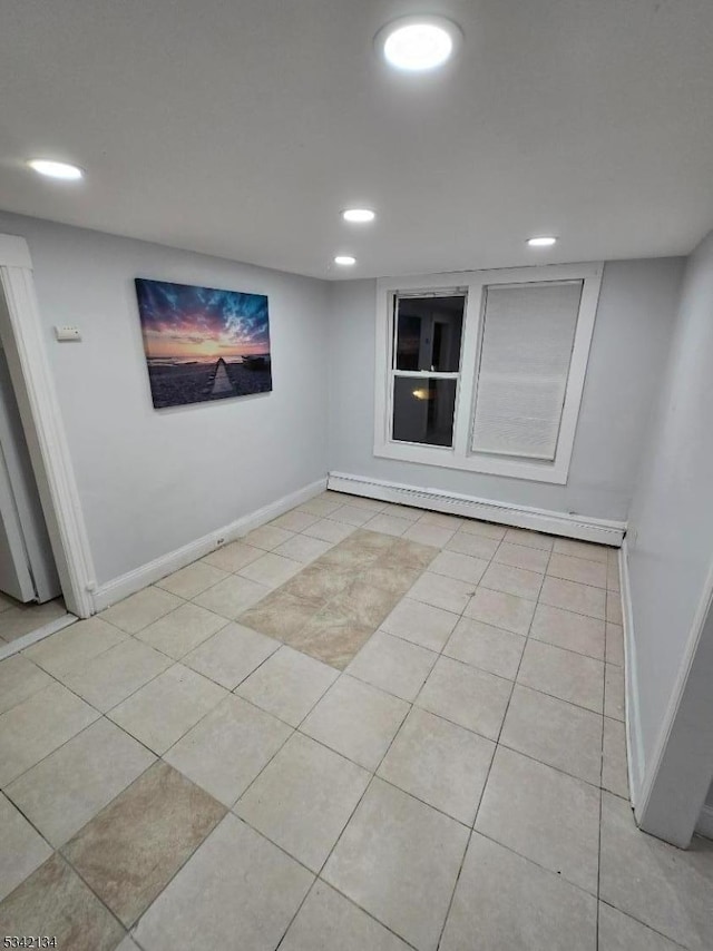 empty room featuring light tile patterned floors, baseboard heating, recessed lighting, and baseboards