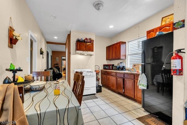 kitchen with light tile patterned floors, recessed lighting, black appliances, and under cabinet range hood