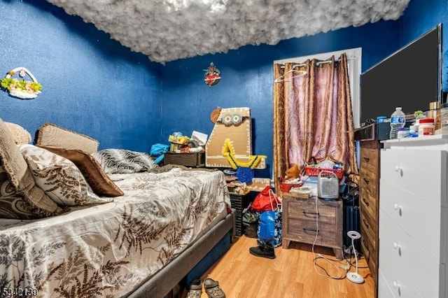 bedroom with wood finished floors