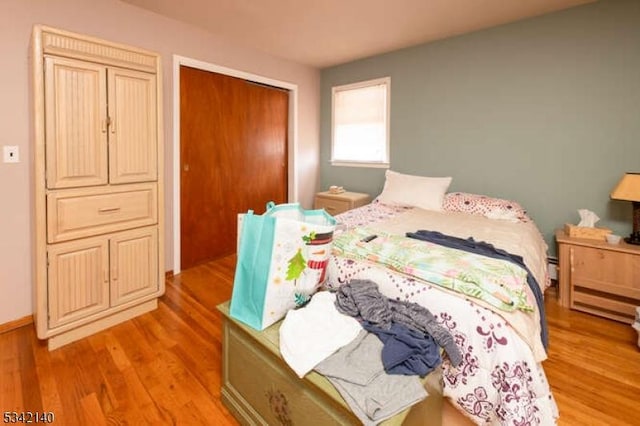 bedroom with a closet and light wood-style flooring