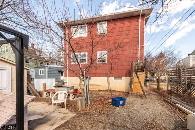 view of side of property featuring fence