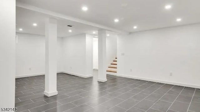 finished basement featuring stairs, baseboards, and recessed lighting