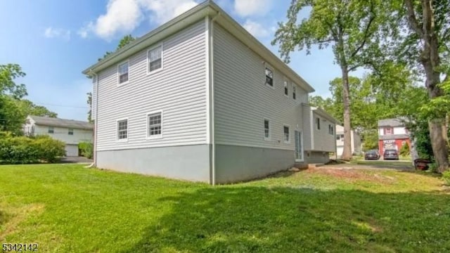 view of property exterior with a lawn