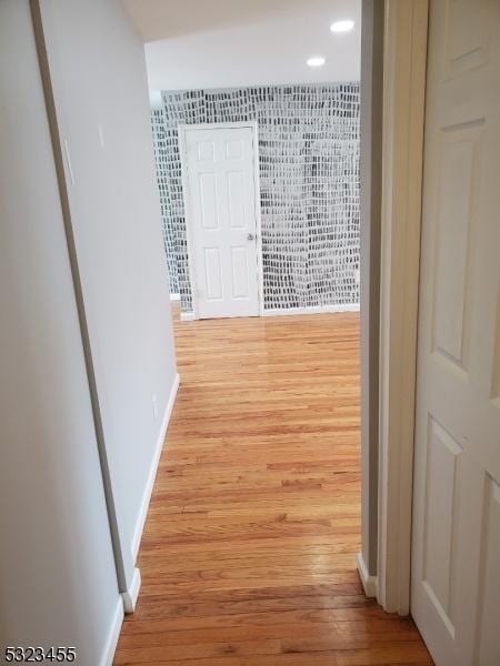 hallway with baseboards and light wood finished floors