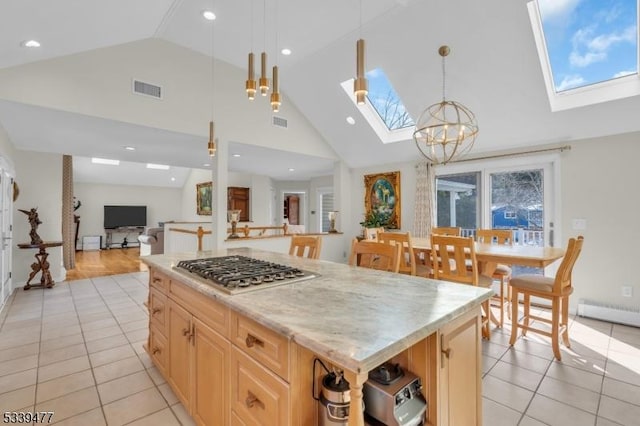 kitchen featuring open floor plan, a skylight, visible vents, and stainless steel gas stovetop