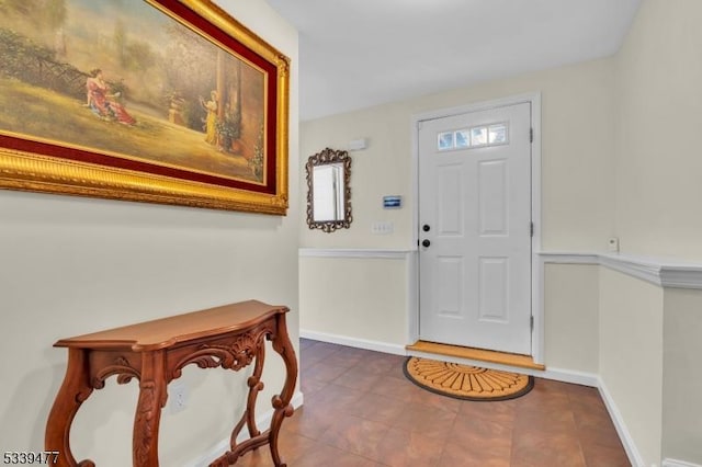 foyer featuring tile patterned flooring and baseboards