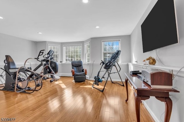 workout room featuring baseboards, wood finished floors, and recessed lighting