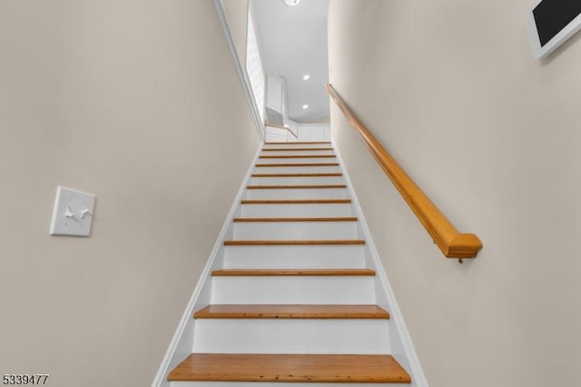 stairs with baseboards and recessed lighting