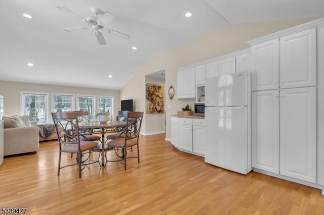 dining area featuring recessed lighting, a ceiling fan, baseboards, vaulted ceiling, and light wood finished floors