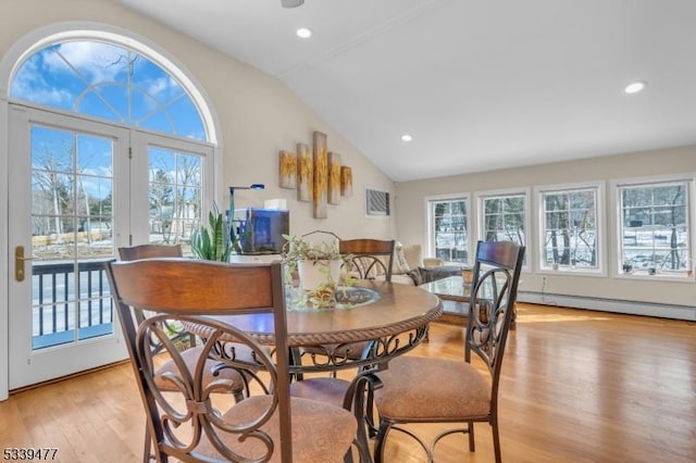 dining space featuring lofted ceiling, light wood-type flooring, a baseboard heating unit, and recessed lighting