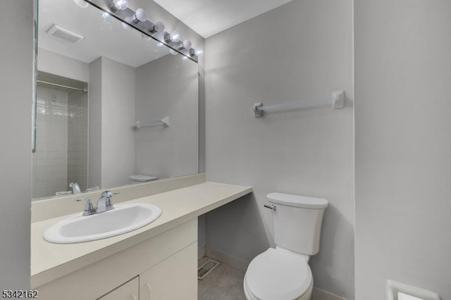 bathroom featuring toilet, baseboards, visible vents, and vanity