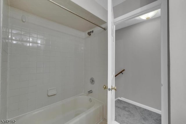 bathroom featuring shower / bathtub combination and baseboards