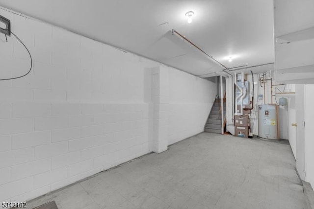 finished basement with stairs, electric water heater, heating unit, and tile patterned floors