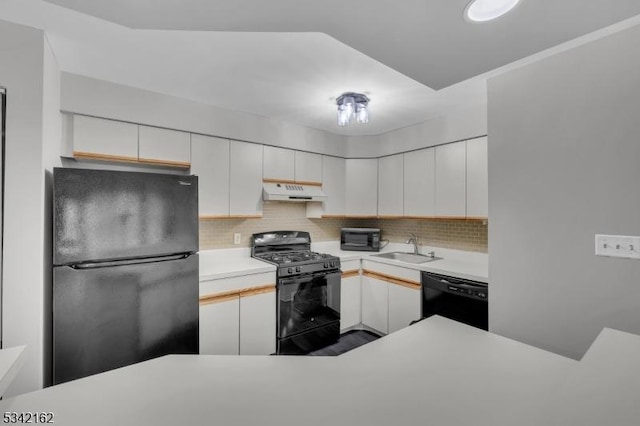 kitchen featuring white cabinets, under cabinet range hood, light countertops, black appliances, and a sink