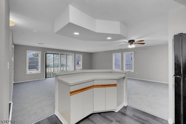 kitchen with freestanding refrigerator, open floor plan, and dark colored carpet