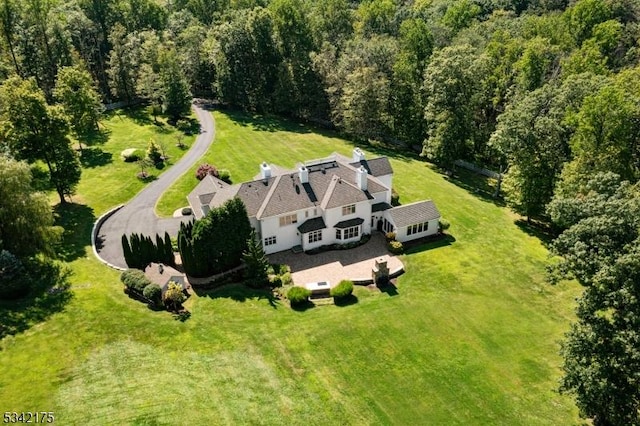 birds eye view of property with a wooded view