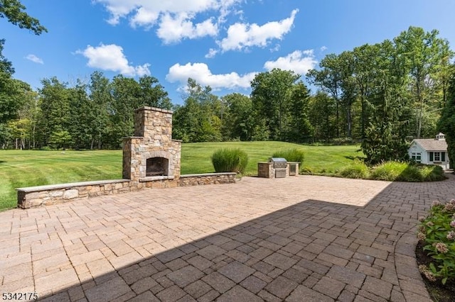 view of patio / terrace with an outdoor stone fireplace