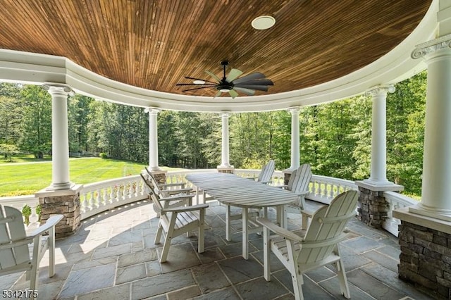 view of patio / terrace with a porch, outdoor dining area, and ceiling fan