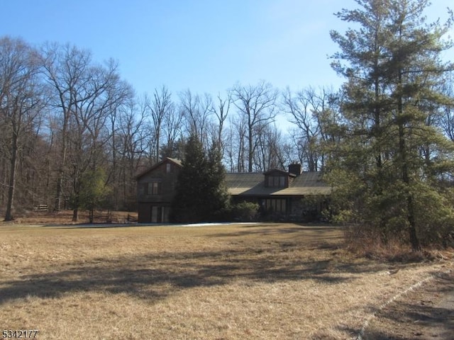 view of side of home with a yard