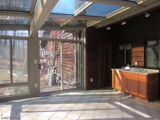 unfurnished sunroom with a sink