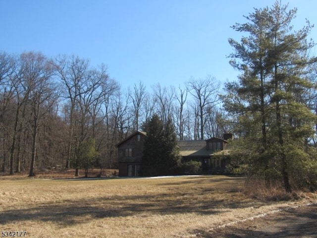 view of side of property with a lawn