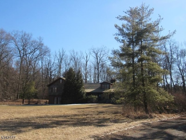 view of property exterior with a yard