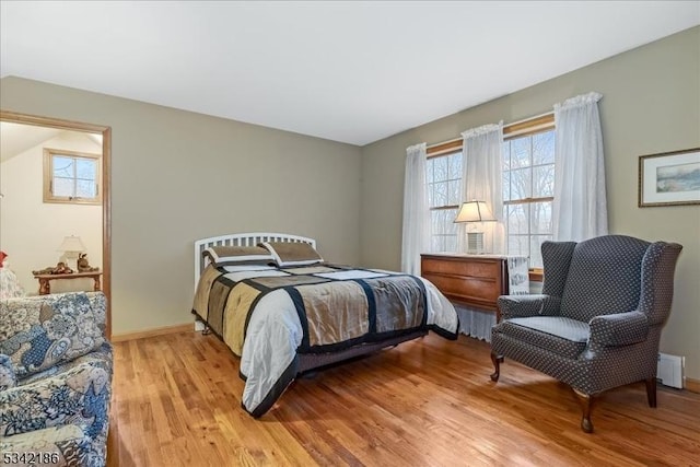 bedroom featuring baseboards and light wood-style floors