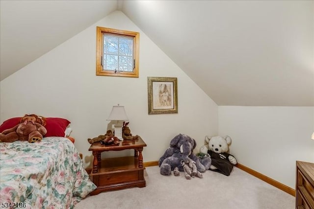 bedroom with lofted ceiling, carpet, and baseboards