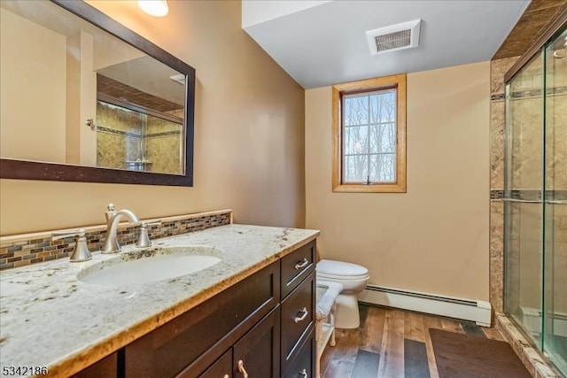 full bathroom featuring visible vents, toilet, wood finished floors, baseboard heating, and a shower stall