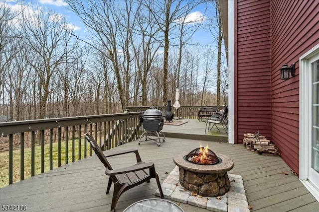 wooden deck featuring a fire pit