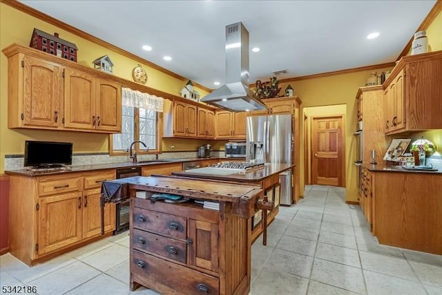 kitchen with crown molding, island exhaust hood, light tile patterned floors, appliances with stainless steel finishes, and a sink