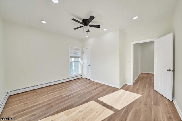 spare room featuring baseboards, a baseboard radiator, light wood-style flooring, and recessed lighting