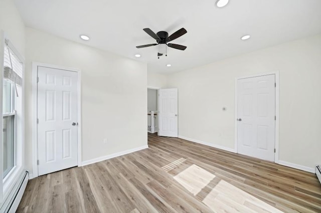 spare room with recessed lighting, light wood finished floors, and baseboard heating