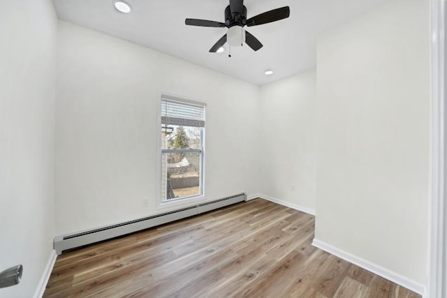 unfurnished room with ceiling fan, a baseboard radiator, recessed lighting, baseboards, and light wood finished floors