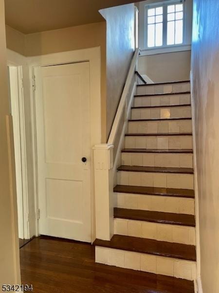 stairs featuring wood finished floors