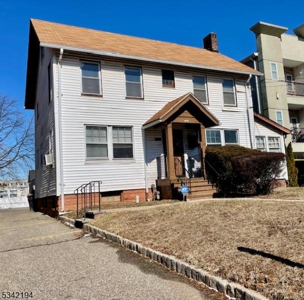 view of front of home featuring a chimney