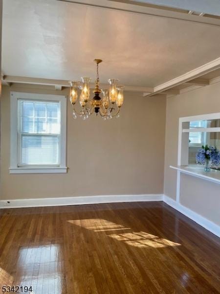 spare room with hardwood / wood-style flooring, beamed ceiling, a notable chandelier, and baseboards