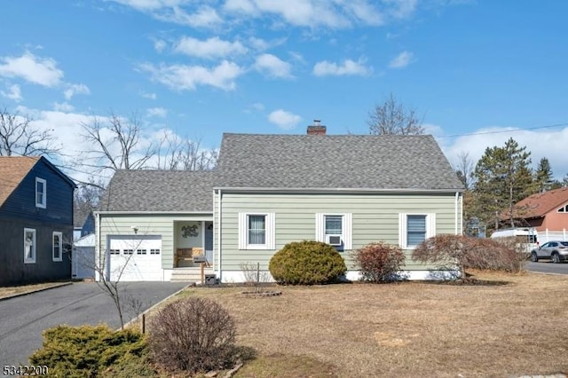 view of front facade with aphalt driveway, roof with shingles, a chimney, and an attached garage