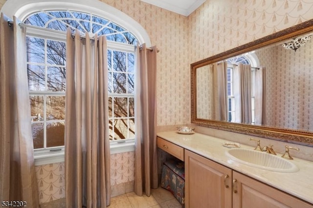 bathroom with tile patterned floors, vanity, and wallpapered walls