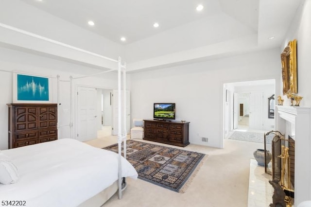 carpeted bedroom featuring a fireplace, connected bathroom, and recessed lighting