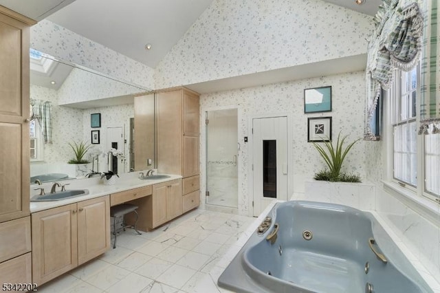 bathroom featuring wallpapered walls, marble finish floor, lofted ceiling with skylight, and a sink