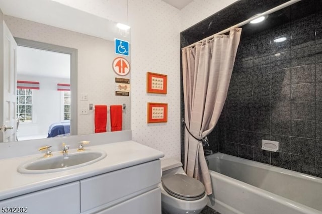 bathroom featuring toilet, wallpapered walls, connected bathroom, and vanity