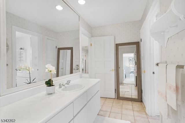 bathroom with recessed lighting, tile patterned floors, vanity, and wallpapered walls