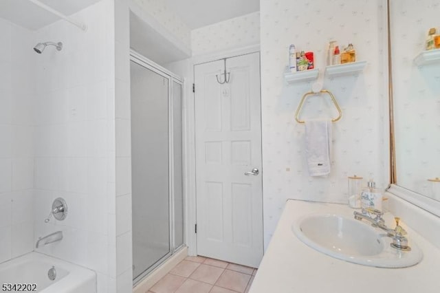 bathroom with wallpapered walls, vanity, an enclosed shower, and tile patterned floors