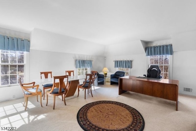 office area featuring visible vents and carpet flooring