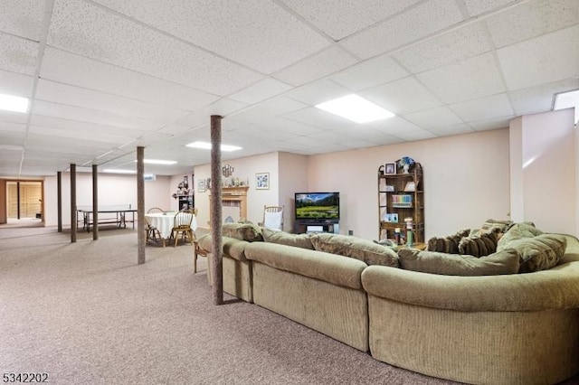 living room featuring carpet flooring and a paneled ceiling