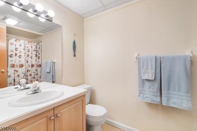 bathroom featuring toilet, a shower with shower curtain, crown molding, and vanity